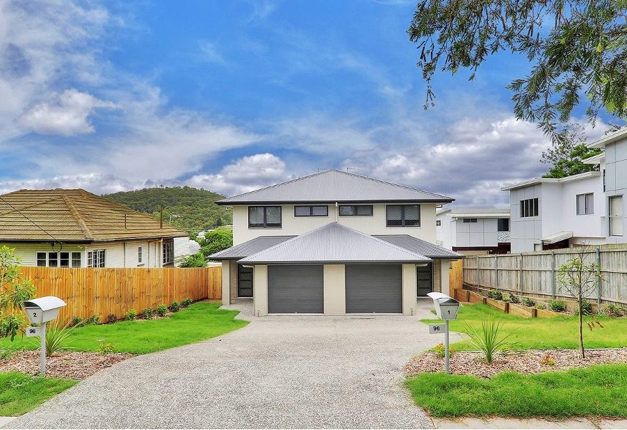 A completed Australian duplex with two garages and two separate mailboxes, showing two separate titles on one block.